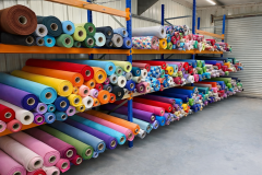 Colourful-fabric-rolls-in-organised-warehouse